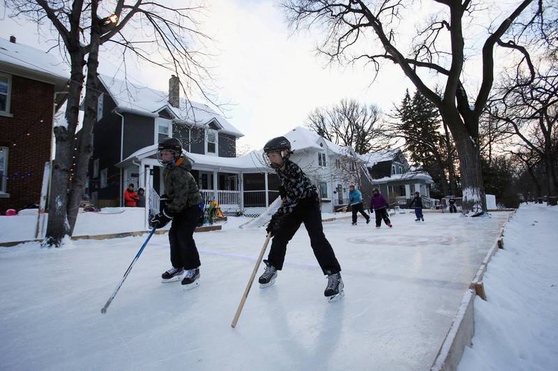 Neighbours skate on the ice rink built across the gardens of three houses in Winnipeg, Manitoba, Canada. Reuters