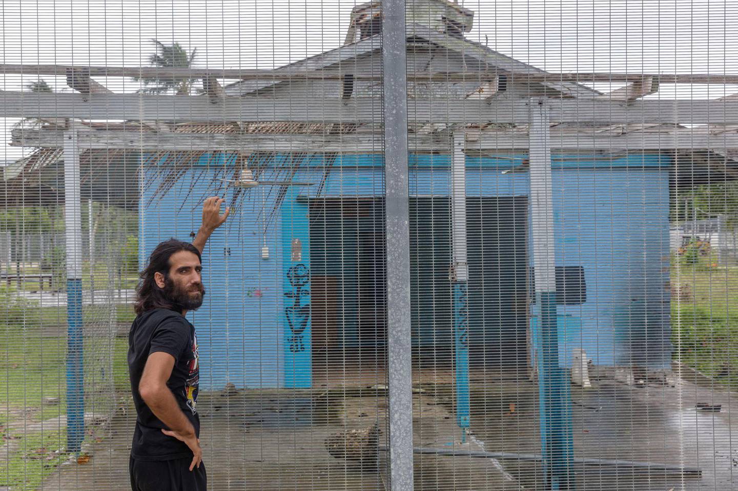MANUS ISLAND, PAPUA NEW GUINEA - 2018/02/06: Asylum seeker Behrouz Boochani, stands outside the  abandoned naval base on Manus island, where he and other asylum seekers were locked up for the first three years.

The human cost of Australias offshore detention policy has been high for those unfortunate enough to have been caught in its net. For asylum seekers trapped on the remote island of Manus in Papua New Guinea, the future remains as uncertain as ever. Australias offshore detention center there was destroyed in 31 October 2017 but for the 600 or so migrants who remain on the remote Pacific island, little has changed. The asylum seekers live with the torment of separation from family and friends and in the shadow of depression and the traumas of their past. (Photo by Jonas Gratzer/LightRocket via Getty Images)