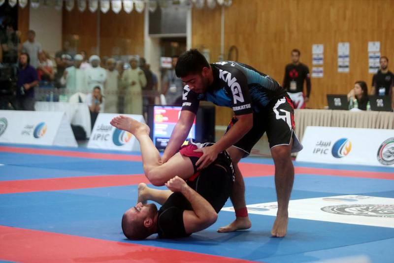 Mohammed Al Qatto, right, of Canada fights Mohammed Shaaban of Lebanon during their blue 90kg quarter-final match in the Ramadan Cup during the AFOCH 19th Open Sports Festival in Abu Dhabi on Saturday. Christopher Pike / The National