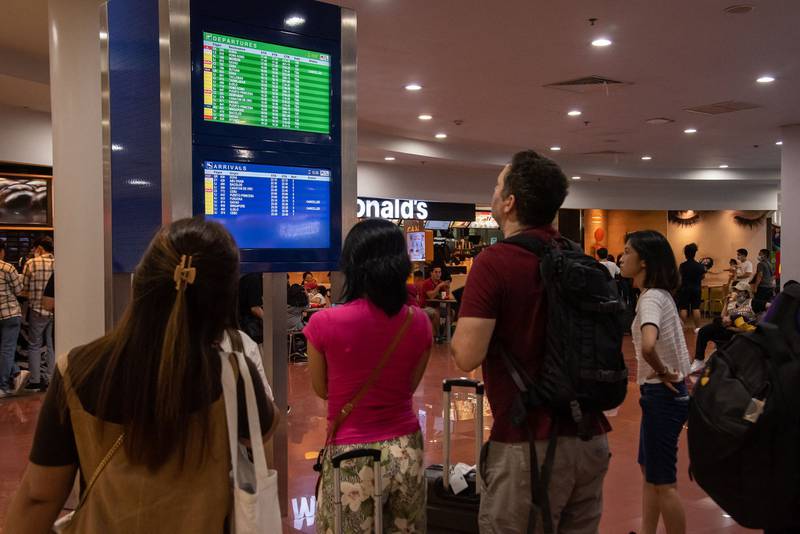 Passengers check a screen for flight information at terminal 3 of Ninoy Aquino International Airport in Pasay.