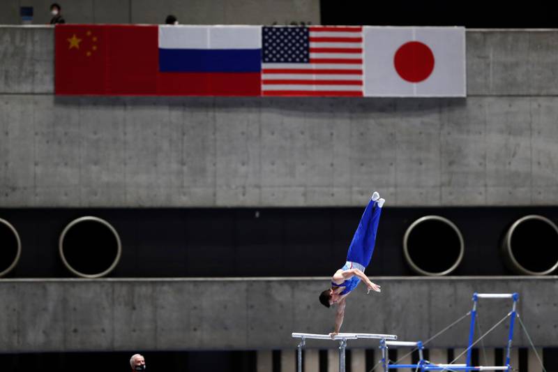 Dimitrii Lankin of Russia competes in the parallel bars. AP