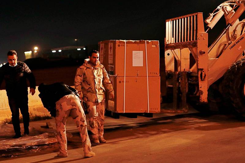 Air freight workers unload the first batch of the Sinopharm vaccine at Baghdad International Airport, Baghdad. As of March 1, Iraq had recorded about 700,000 cases of Covid-19, with more than 13,400 deaths. AP Photo