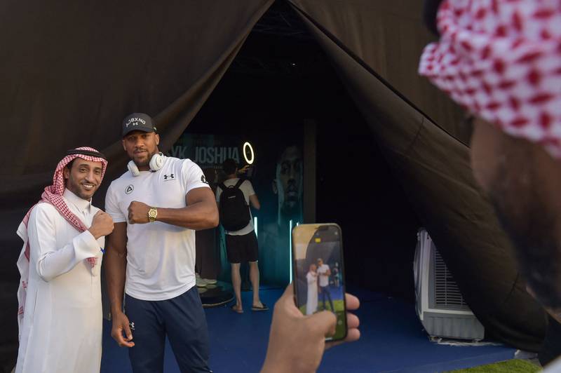 Britain's Anthony Joshua poses for a picture with a fan. AFP