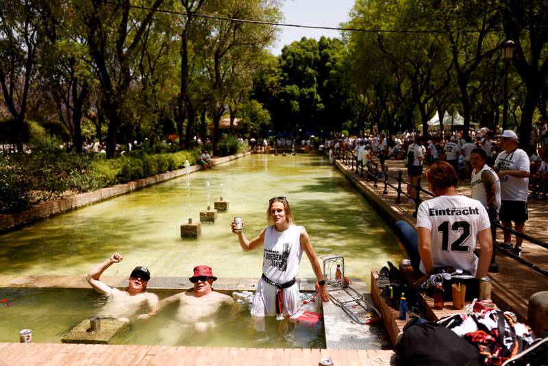 Eintracht Frankfurt fans cool off in a fan zone in Seville. Reuters
