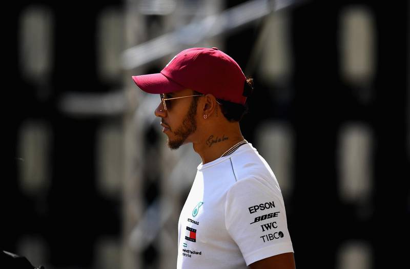 Mercedes' Lewis Hamilton walks in the Paddock. Getty