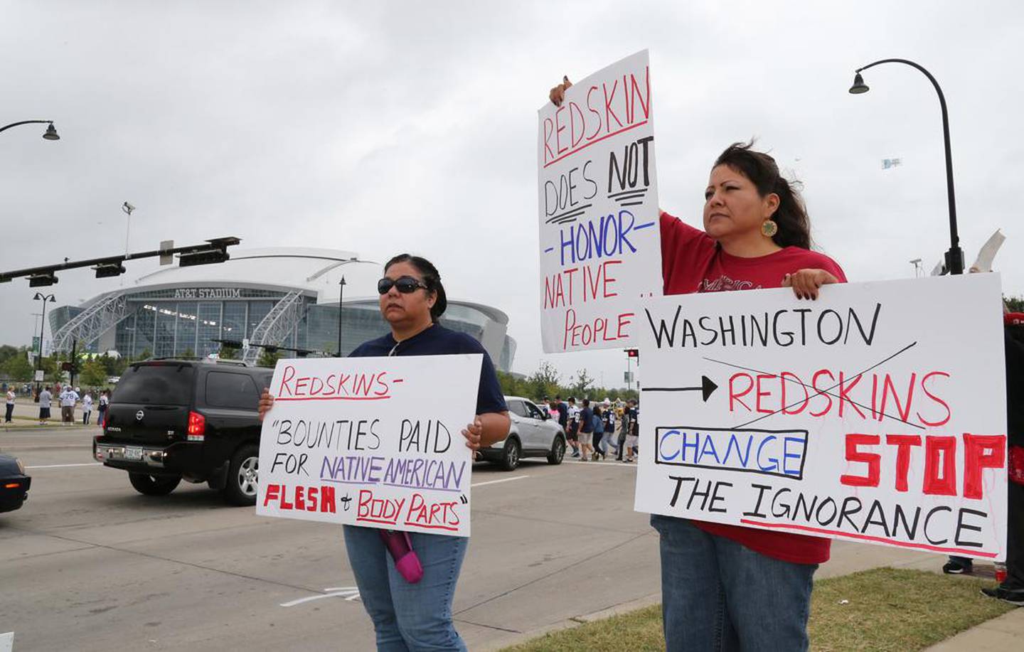 Native Americans Diana Parton, left, and Yolonda Bluehorse protest against the football team's nickname, which was changed last year due to mounting pressure. USA Today

