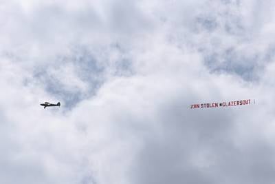 A plane trailing a banner that reads "2bn Stolen Glazers Out" is flown over the stadium prior to the Premier League match between Leeds United and Manchester United in April 2021