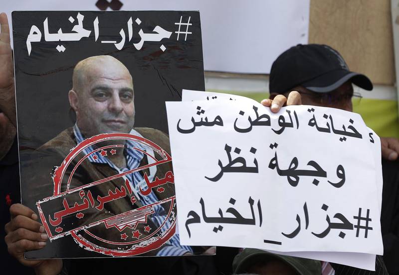 (FILES) In this file photo members of the Lebanese Shiite Amal movement on September 15, 2019,  hold a photograph of Amer al-Fakhoury, dring a  demonstration in front of the former Israeli-run prison of Khiyam on the border with Israel, to demand his trial.  A former member of a pro-Israel Lebanese militia accused by witnesses of torture was released March 19, 2020 to the United States, where he is a naturalized citizen, President Donald Trump said.Trump said that Amer al-Fakhoury, a former member of the South Lebanon Army (SLA) who was detained on his return to Beirut in September, was suffering late-stage cancer.  / AFP / JOSEPH EID 