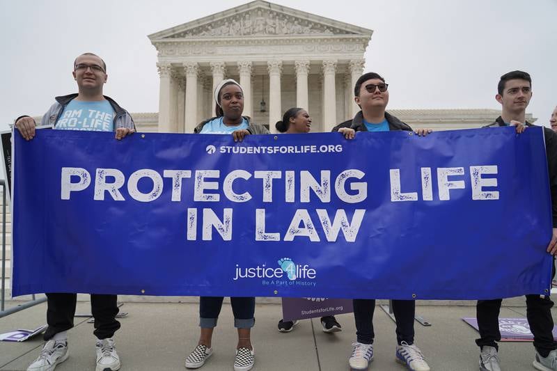 Members of the pro-choice group Students for Life of America pose in front of the Supreme Court. Willy Lowry / The National