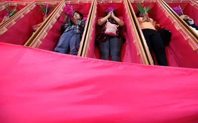 Worshippers pray as they take turns lying in coffins at the Takien temple in suburban Bangkok, Thailand. Worshippers believe that the coffin ceremony – symbolising death and rebirth – helps them rid themselves of bad luck and are born again for a fresh start in the new year. AP Photo