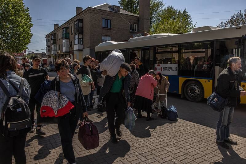 People with their luggage walk to a station to wait for the evacuation train heading to the west of Ukraine, in Pokrovsk, Donetsk region. EPA