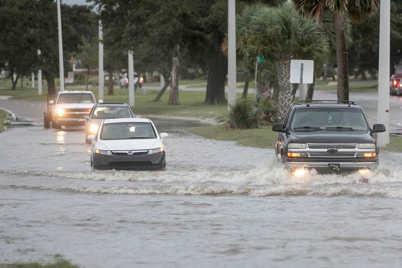Vehicles on a flooded street in Biloxi. AP