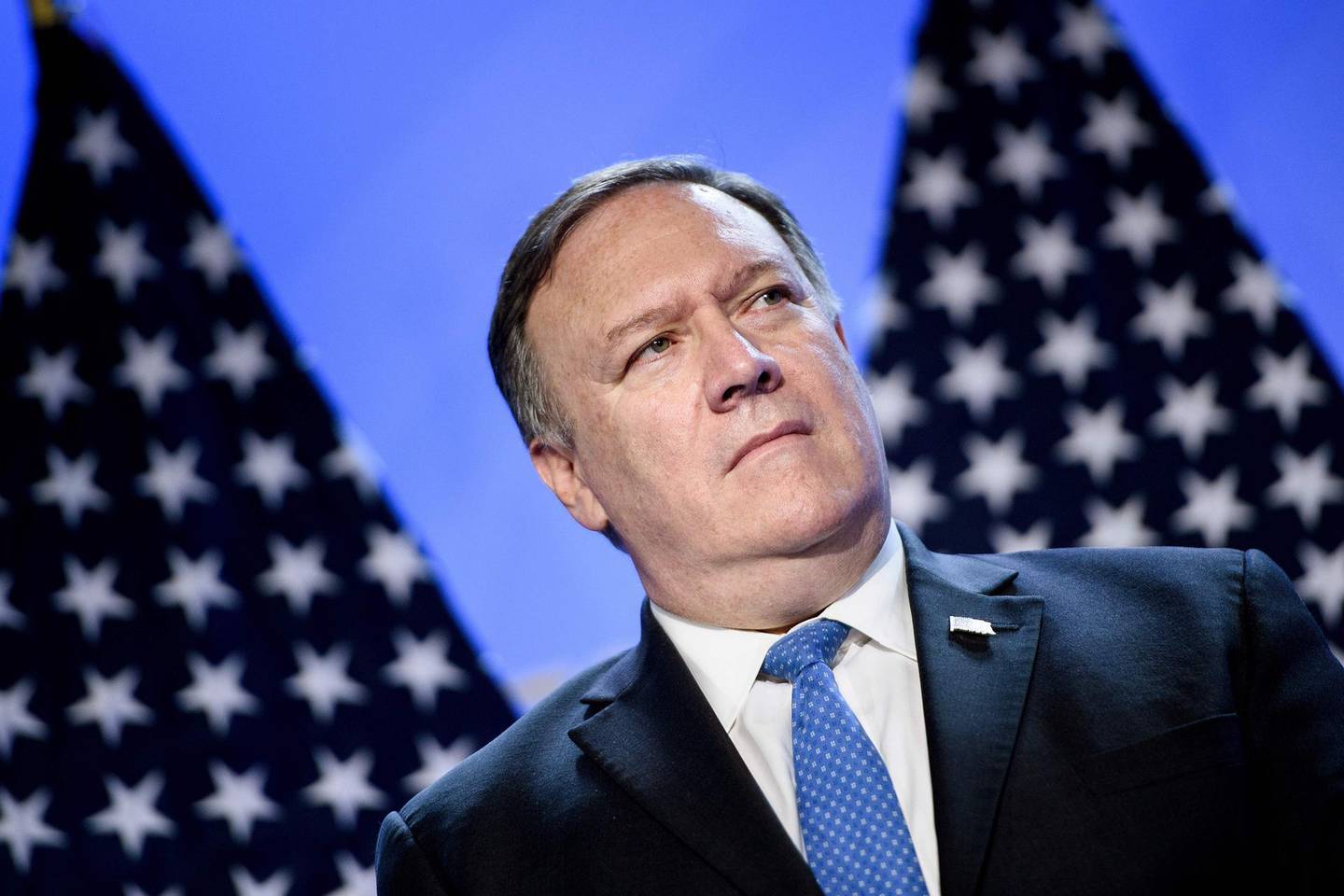 (FILES) In this file photo taken on July 11, 2018 US Secretary of State Mike Pompeo looks on as US President Donald Trump addresses a press conference on the second day of the North Atlantic Treaty Organization (NATO) summit in Brussels. The United States is not "afraid to tackle" Iranian officials with sanctions at the "highest level" of its government, Secretary of State Mike Pompeo said on July 22, 2018. Pompeo also confirmed that Washington wants all countries to reduce their imports of Iranian oil "as close to zero as possible" by November 4, part of US efforts to increase economic pressure on Tehran. / AFP / Brendan Smialowski
