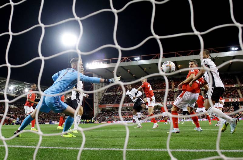 Fulham's Tosin Adarabioyo scores past Nottingham Forest's Dean Henderson. Reuters