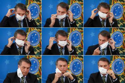 A combination of picture shows Brazil's President Jair Bolsonaro adjusting his protective face mask during a press statement to announce federal judiciary measures to curb the spread of the coronavirus disease (COVID-19) in Brasilia. REUTERS