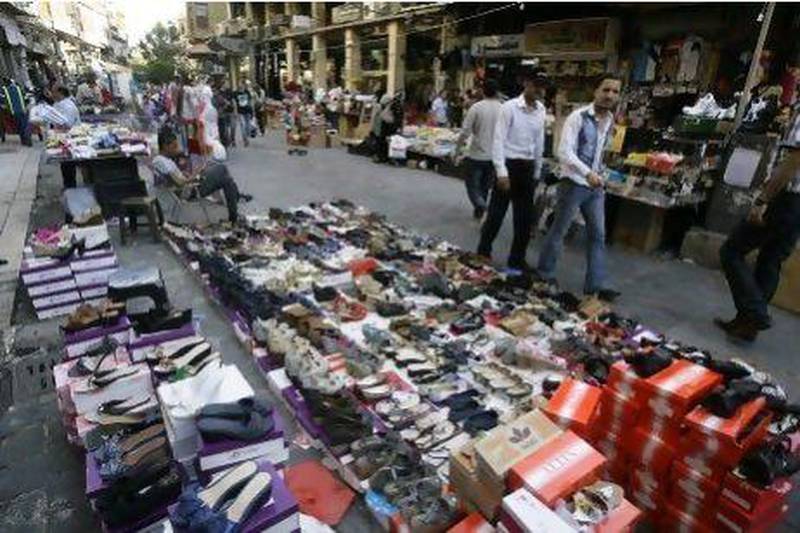 Syrian street vendors display shoes and clothes for sale in a pedestrian area in downtown Damascus. AFP PHOTO/JOSEPH EID