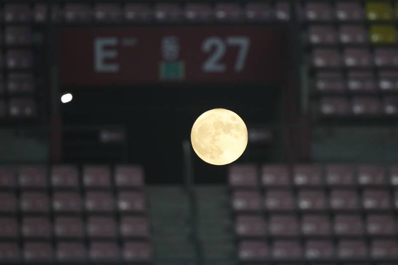 The full moon is seen rising behind the Jeonju World Cup Stadium in Jeonju, South Korea. Photo: Reuters