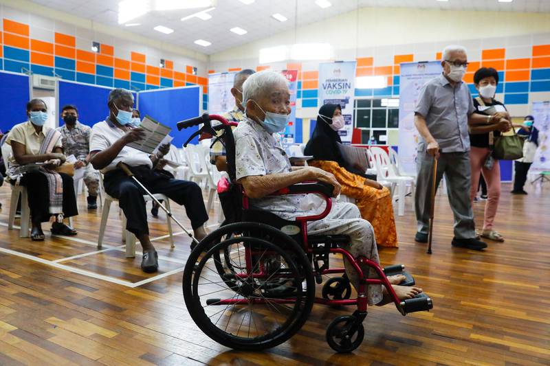 An elderly woman waits for her turn to receive a dose of Pfizer-BioNTech coronavirus vaccine in Port Klang, on the outskirts of Kuala Lumpur, Malaysia. EPA