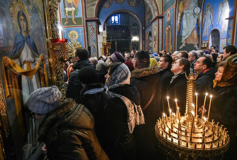 People attend the first liturgy since the creation of a new Ukrainian church independent from Russia in the Saint Michael’s Golden-Domed Cathedral in Kiev on December 16, 2018. On December 15, a historic council of Orthodox bishops in Kiev created a new Ukrainian church independent from Russia. The move followed a synod by Ukrainian priests in Kiev's 11th-century Saint Sophia Cathedral which was snubbed by representatives of the Moscow-loyal branch. The council of bishops chose as the head of the new church 39-year-old Metropolitan Yepifaniy, whose secular name is Sergiy Dumenko. 
 / AFP / Genya SAVILOV
