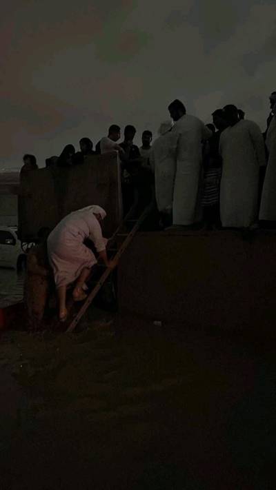 Servicemen move residents to dry ground. Photo: UAE Ministry of Defence