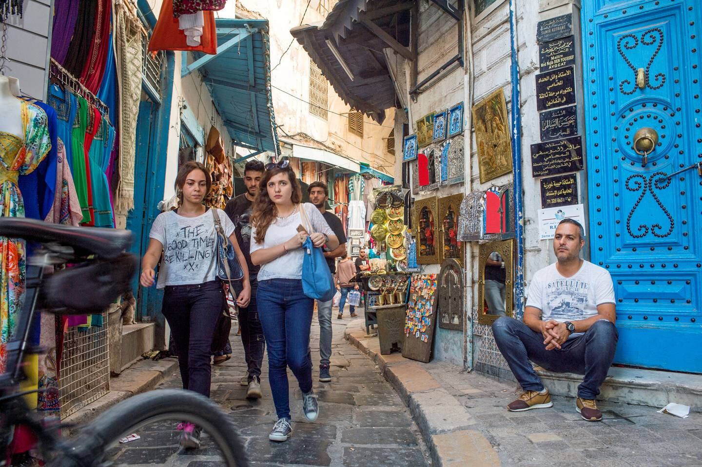TUNIS, TUNISIA - OCTOBER 4: Shoppers pass through the narrow alleys in the souks of the Medina on October 4, 2016 in Tunis, Tunisia. The Medina, a quarter of Tunis housing souks, mausoleums, monuments and cafes, is built around the Zitouna Mosque and became a UNESCO World Heritage Site in 1979. (Photo by Ann Hermes/The Christian Science Monitor via Getty Images)