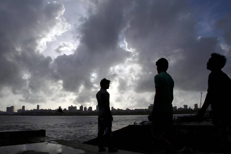 Pre-monsoon clouds against the Mumbai skyline on Thursday. India’s seasonal rains are late for a second year in a row, which threatens the economy. Rajanish Kakade / AP Photo