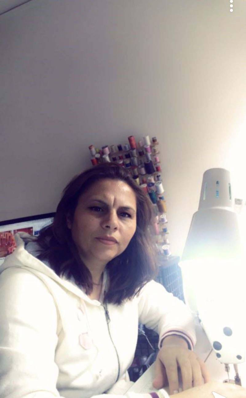 Amina Ahmad came to the US from Syria and now runs her own alterations business. Courtesy neighbours for refugees

