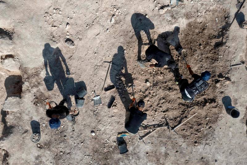 An aerial photo taken by drone shows archaeologists working at the Tomb of Salome work at the Salome Cave in the Lachish national park west of Jerusalem, on December 20 2022.  - Israel today unveiled pilgrims' lamps and other finds from the so-called Tomb of Salome, an early Christian burial site named for a woman said to have assisted at the birth of Christ.  (Photo by MENAHEM KAHANA  /  AFP)