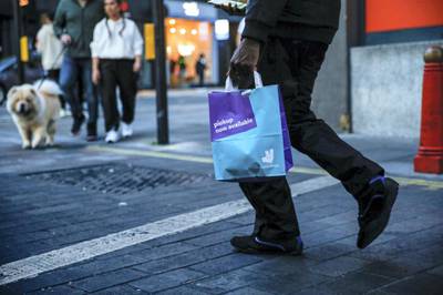 A takeaway food courier, working for Deliveroo, operated by Roofoods Ltd., walks with a customer's food order in London, U.K., on Tuesday, Sept. 29, 2020. Covid-19 lockdown enabled online and app-based grocery delivery service providers to make inroads with customers they had previously struggled to recruit, according the Consumer Radar report by BloombergNEF. Photographer: Hollie Adams/Bloomberg via Getty Images
