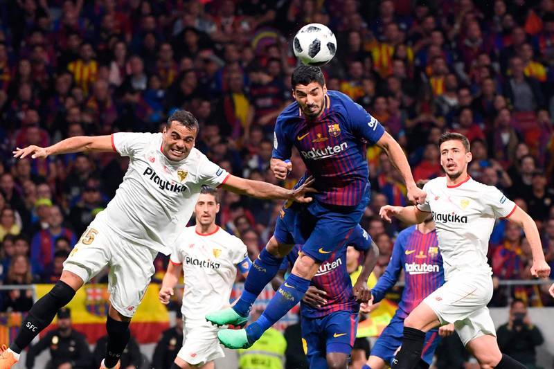 Barcelona forward Luis Suarez, centre, heads the ball during their Copa del Rey final against Sevilla at the Wanda Metropolitano Stadium in Madrid. Pierre-Philippe Marcou / AFP