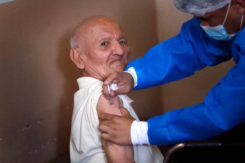 A nurse administers an AstraZeneca Covid-19 vaccine to an elderly patient at Santo Domingo home for the elderly in Asuncion, Paraguay. AP