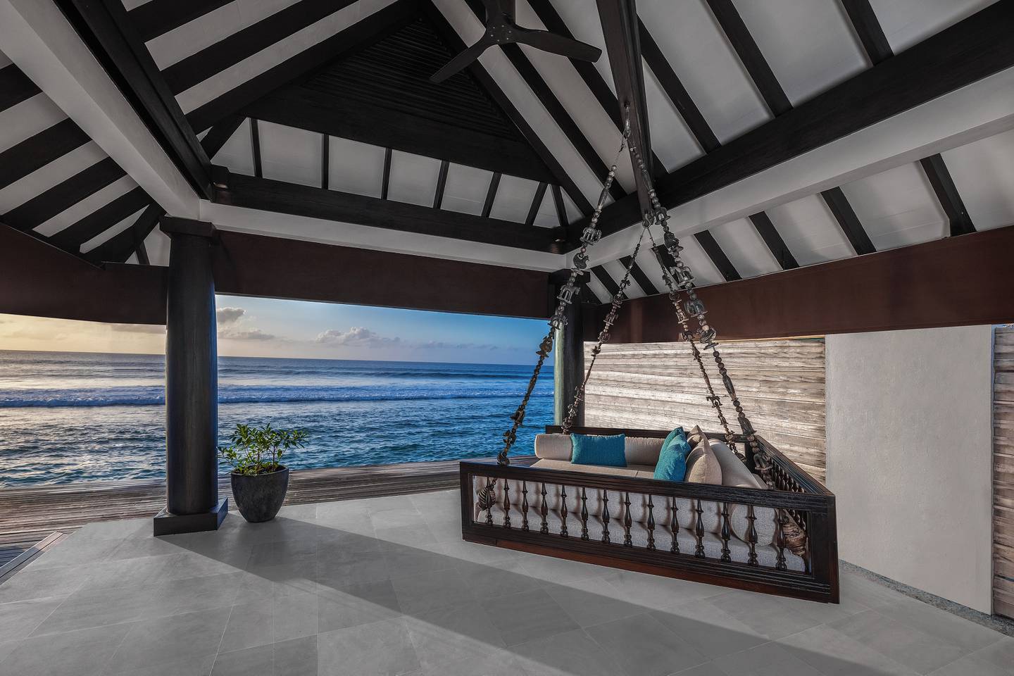 A day bed suspended on the terrace of an Ocean House.  Photo: Naladhu Private Island