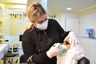 Female worker wearing masks and gloves works in teauty salon in one of the neighborhoods of Damascus, Syria. EPA
