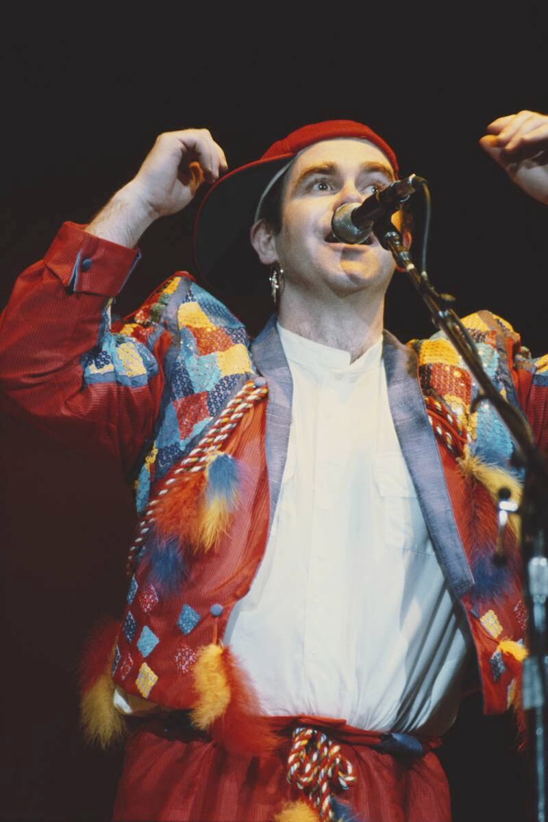 Elton John, in a red patchwork suit, performs at the Hammersmith Odeon in London on December 16, 1982. Getty Images