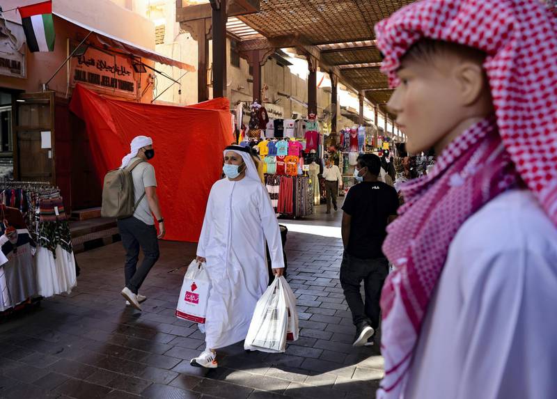 Emiratis shop at the Dubai grand market, in the Gulf city of Dubai, on January 6, 2021. (Photo by Karim SAHIB / AFP)