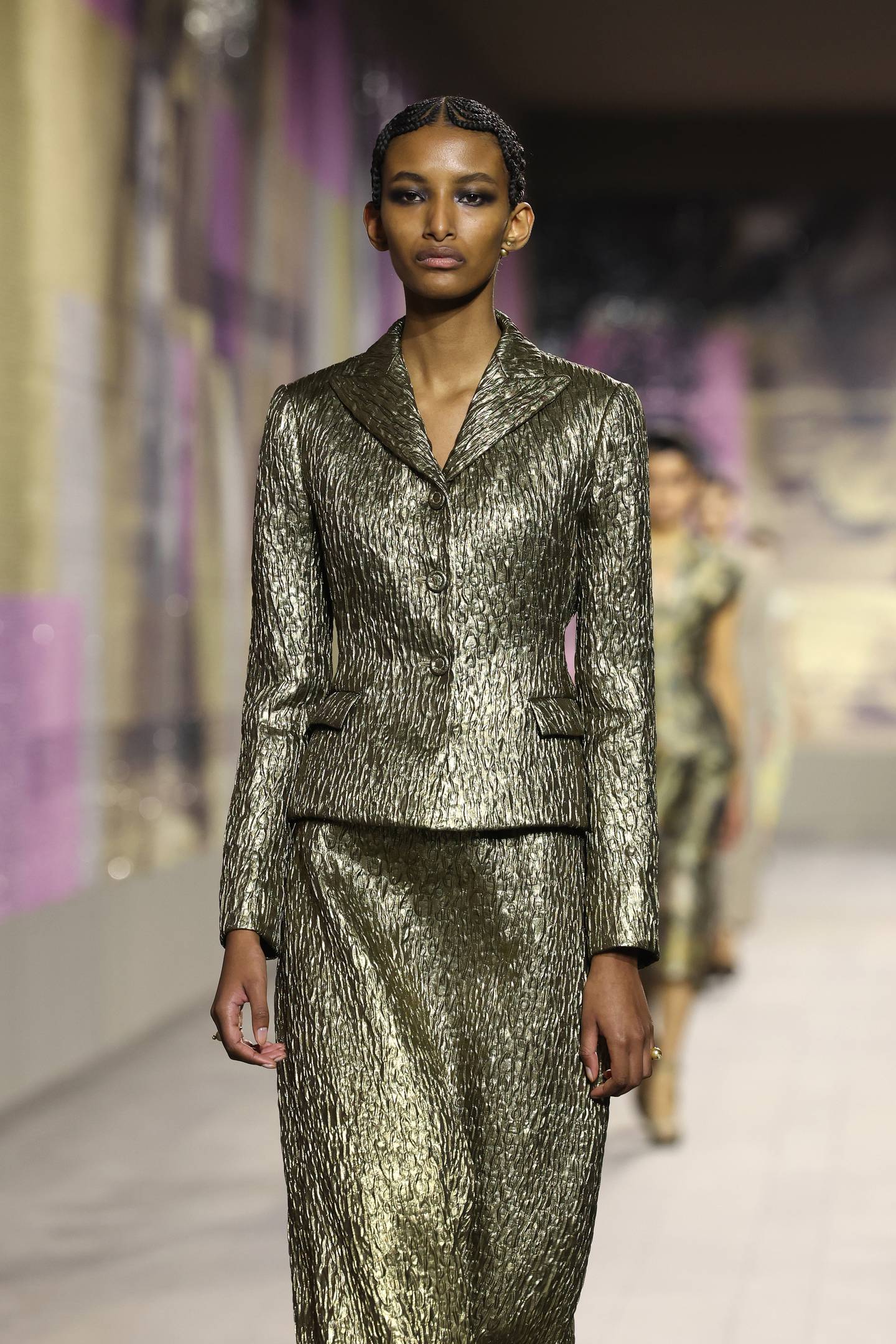 Impeccable tailoring at the Christian Dior Haute Couture spring/summer 2023 show, where gold cloth has been cut into a loosely shaped skirted suit. Getty Images