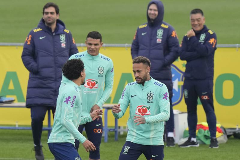 Neymar, right, jokes with teammate Marquinhos. AP