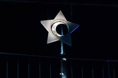 A view of a decoration showing a crescent moon inlaid inside a five-pointed star bearing calligraphic text in Arabic reading "Ramadan Mubarak", placed along a fence in the City Walk district of Dubai, with the Burj Khalikfa skyscraper in the background.  AFP