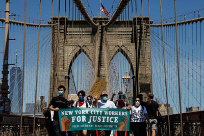 Current and former New York City Mayor's staff march across the Brooklyn Bridge. REUTERS