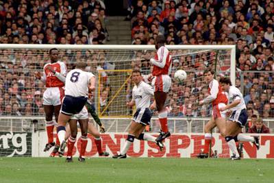 Tottenham Hotspur's Paul Gascoigne (left, white shirt, No 8) takes a free kick and scores against Arsenal, during their FA Cup semi-final football match at Wembley Stadium, in London.   (Photo by John Stillwell - PA Images/PA Images via Getty Images)