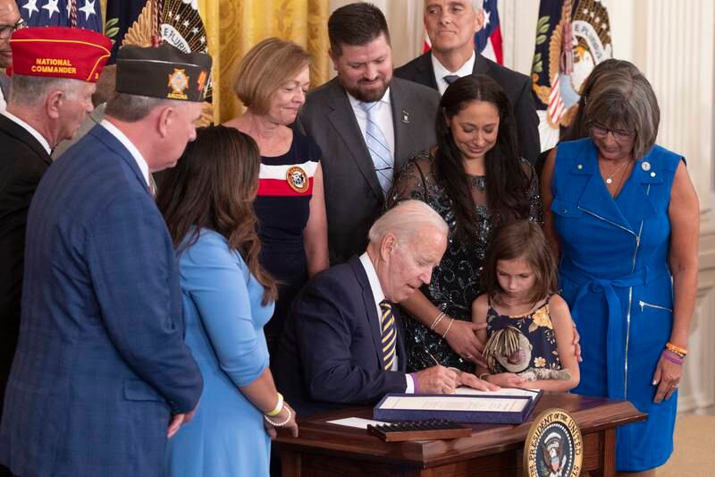 US President Joe Biden signs the Pact Act into law, during a ceremony in the East Room of the White House in Washington. EPA