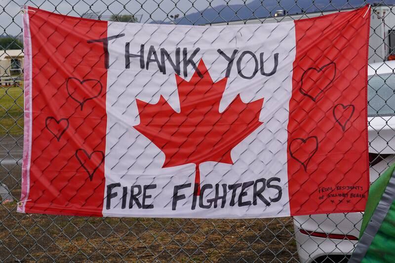 A thank you sing written on a Canadian flag hangs at the entrance to a firefighters camp in Vernon, BC. Willy Lowry / The National