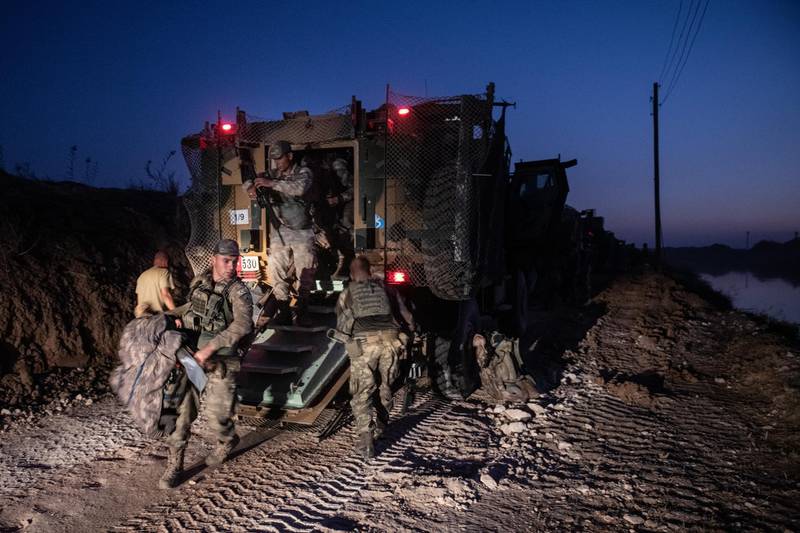 The first group of Turkish infantry prepare to enter Syria on the border between Turkey and Syria on October 9 in Akcakale, Turkey. Getty Images