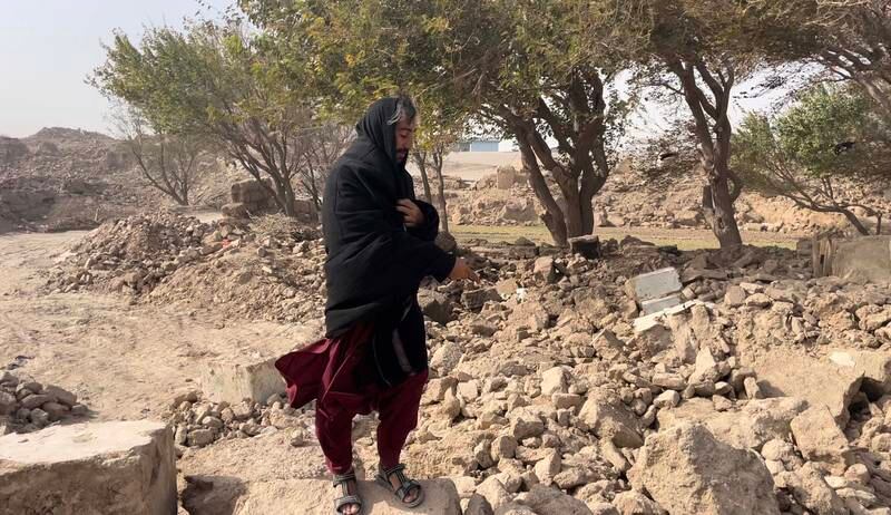 Abdul Latif points out what is left of his home in the village of Sia Ab in western Afghanistan. Sulaiman Hakemy / The National