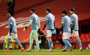 Manchester City players in tribute No 8 shirts in memory of Colin Bell before the League Cup semi-final against Manchester United at Old Trafford. PA