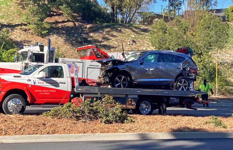 Tiger Woods' car is towed away in Los Angeles in April after the crash that smashed his leg. Getty
