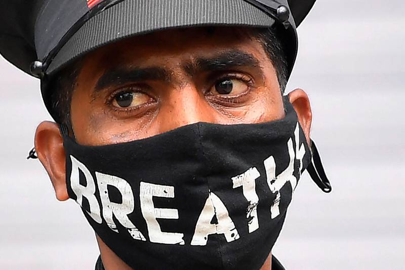A security guard wearing a facemask as a preventive measure against the Covid-19 coronavirus is pictured in Mumbai. India's coronavirus cases surged past seven million on October 11, taking it ever closer to overtaking the United States as the world's most infected country.  AFP
