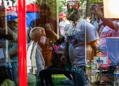 People wear Donald Trump T-shirts as Mike Pence gives an interview at the Iowa State Fair in Des Moines. Reuters