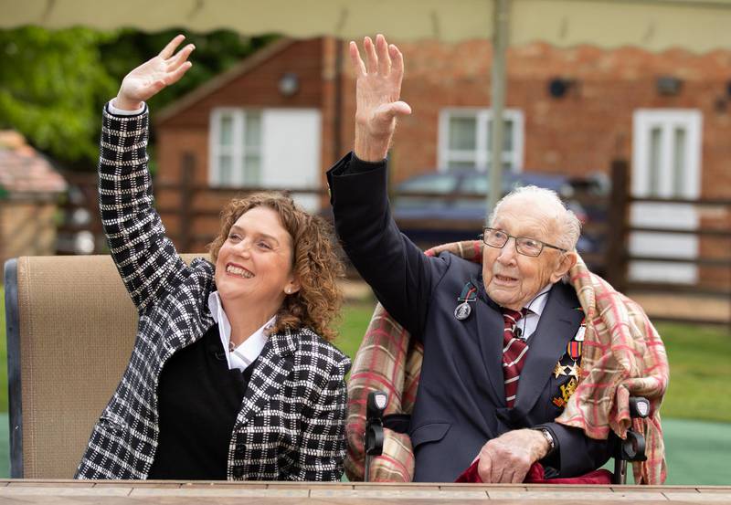 Captain Tom and his daughter Hannah celebrate his 100th birthday, with an RAF flypast provided by a Spitfire and a Hurricane over his home. Getty Images