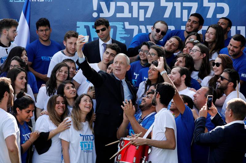 Benny Gantz, leader of Blue and White party, takes a selfie together with supporters outside the party headquarters in Tel Aviv, Israel April 8, 2019. REUTERS/Amir Cohen